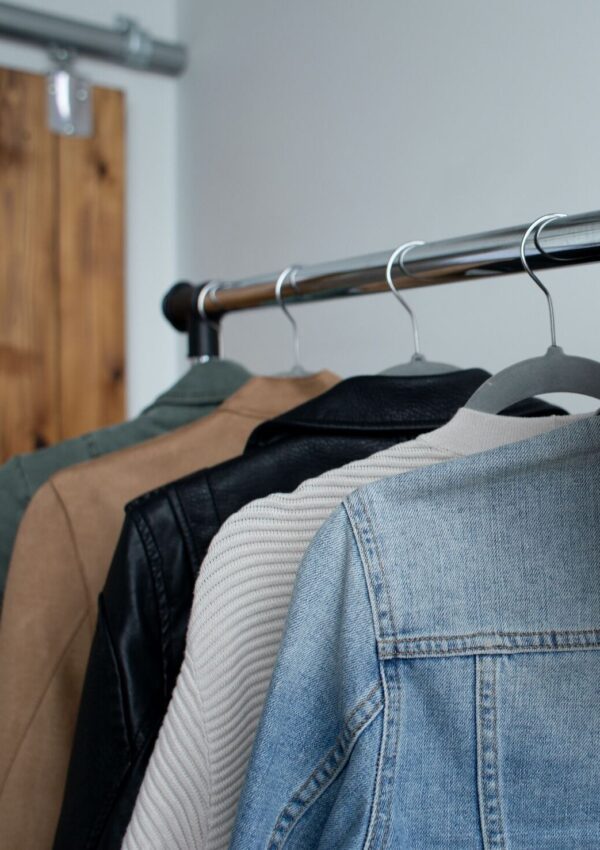 a minimalist wardrobe on a clothing rack