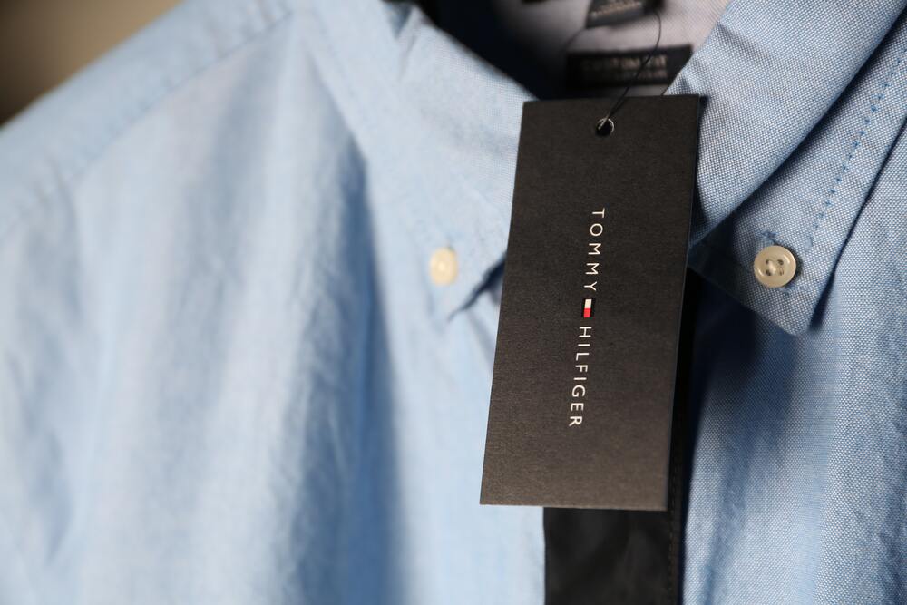 A shirt with a tag on it that represents what not to own for a minimalist wardrobe
