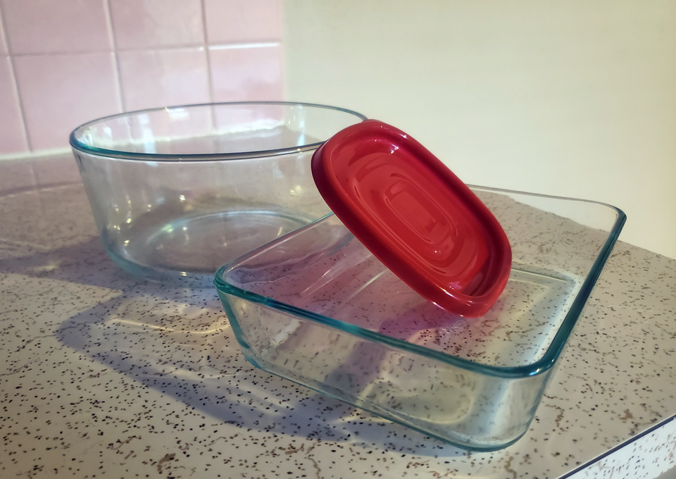 An image of two stacked food storage containers and a red lid that I got rid of during my declutter