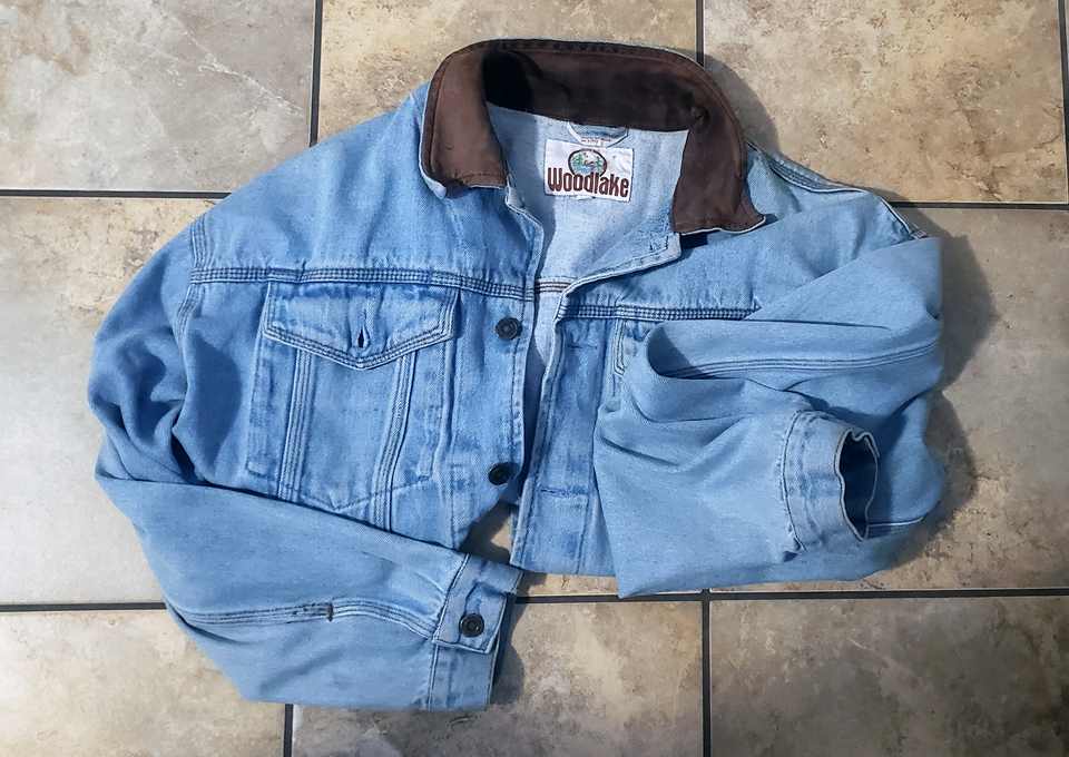 An image of a folded denim jacket with a leather collar that I got rid of during my declutter