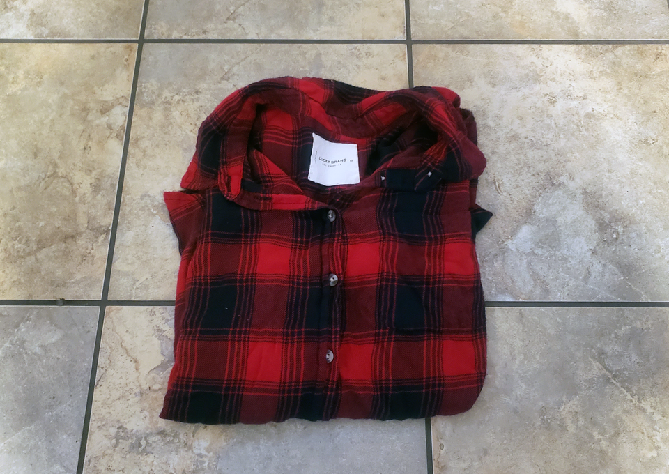 An image of a folded red flannel that I got rid of during my declutter