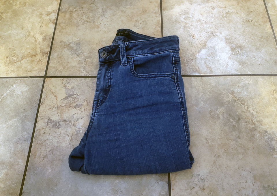 An image of a folded up pair of jeans that I got rid of during my declutter
