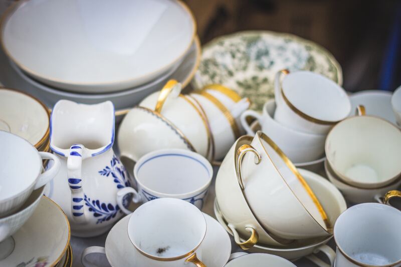 Teacups, saucers and serving bowls stacked on a surface