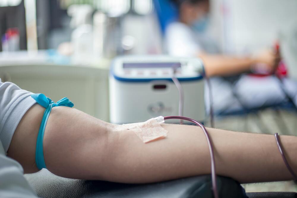 A close up image of a person's arm getting blood drawn.