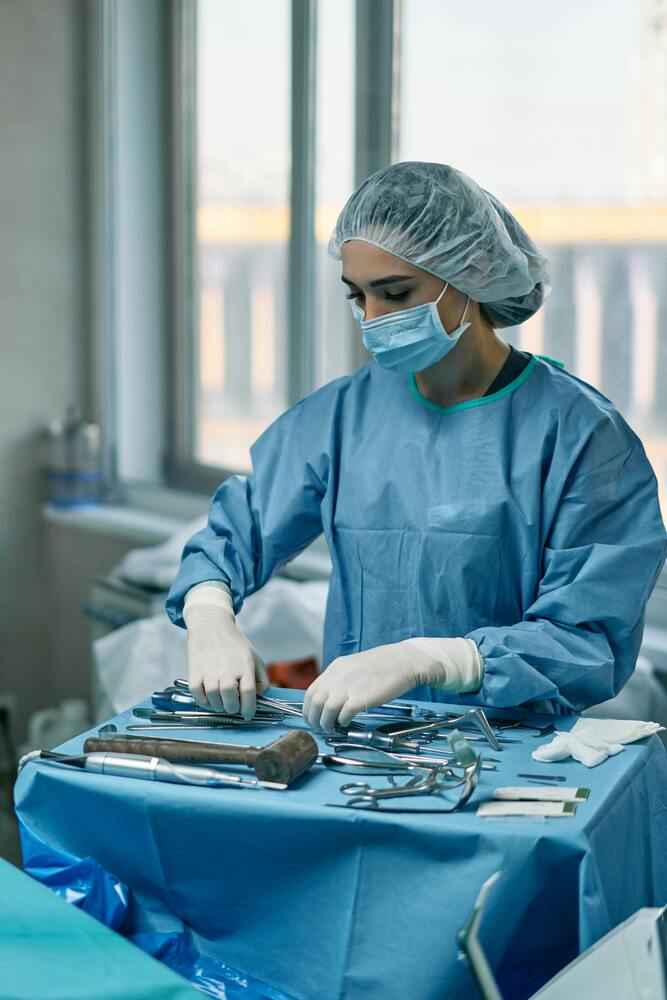A female surgical technologist preparing a surgery room